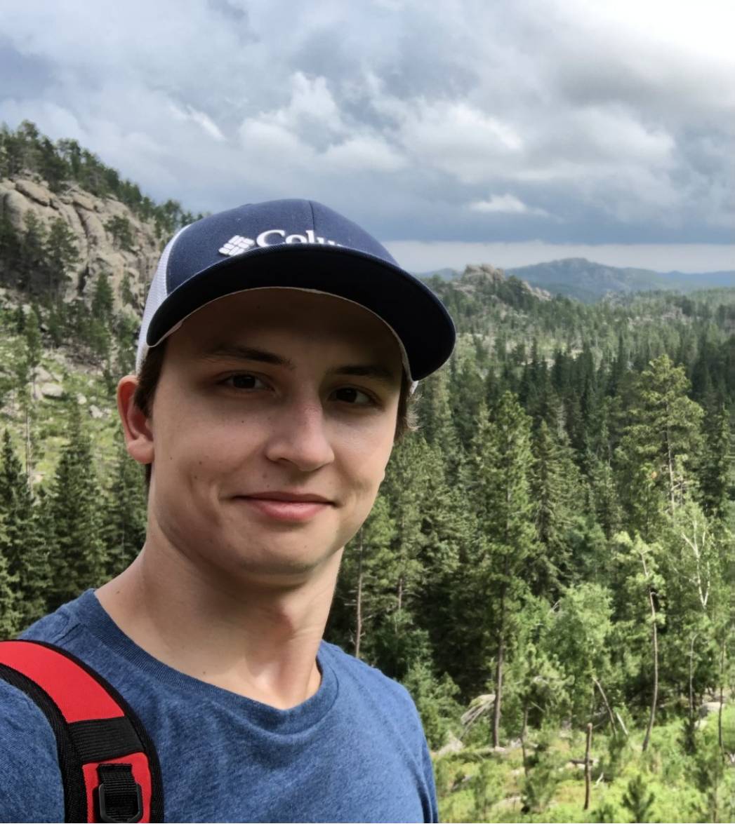 Ben Joseph with a forest and mountains in the background
